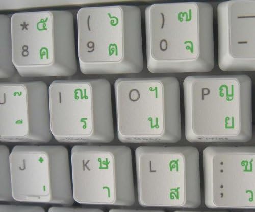 מדבקת מקלדת תאילנדית עם כיתוב ירוק על רקע שקוף לשולחן עבודה, מחשב נייד ומחברת
